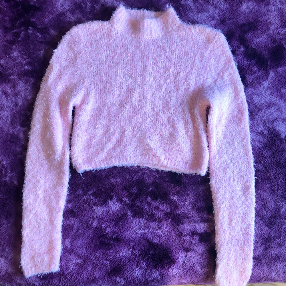 Cropped pink fuzzy sweater.